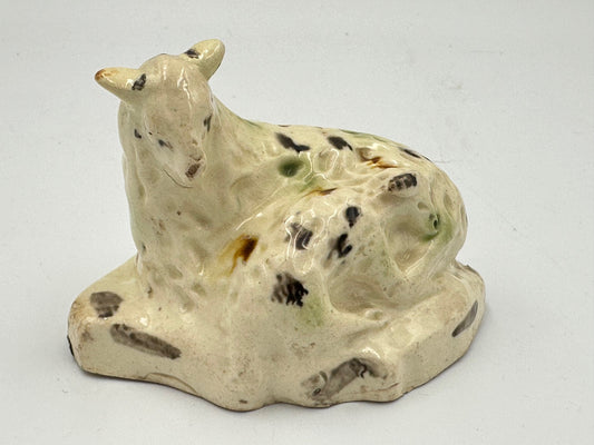 Antique ceramic figurine of a ewe and lamb with a green, black, and brown tortoise shell pattern on a flatback base.