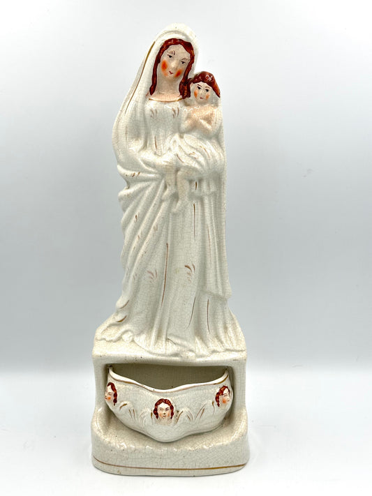 Staffordshire Flatback figurine depicting Jesus, Mary, and the Holy Water stoup, with hand-painted faces, in antique condition.