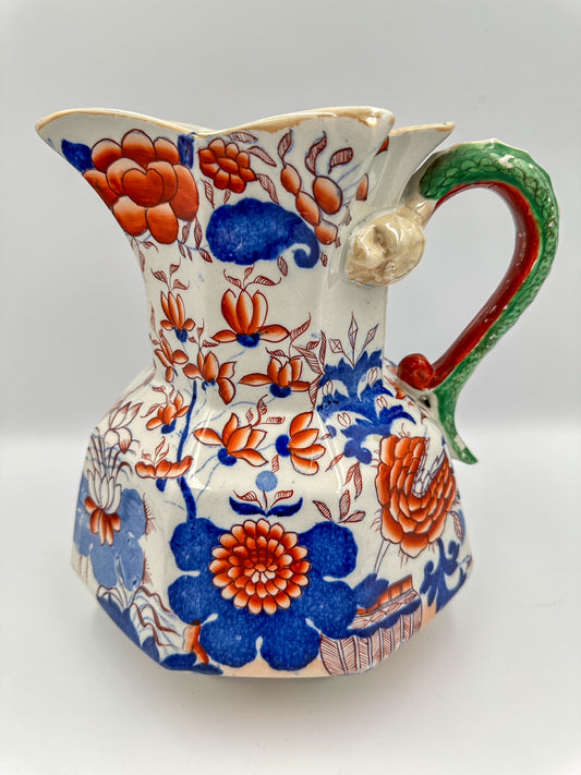 A large antique Mason's Ironstone Imari Hydra Jug with a snake handle, featuring floral patterns in blue and red on a white background.