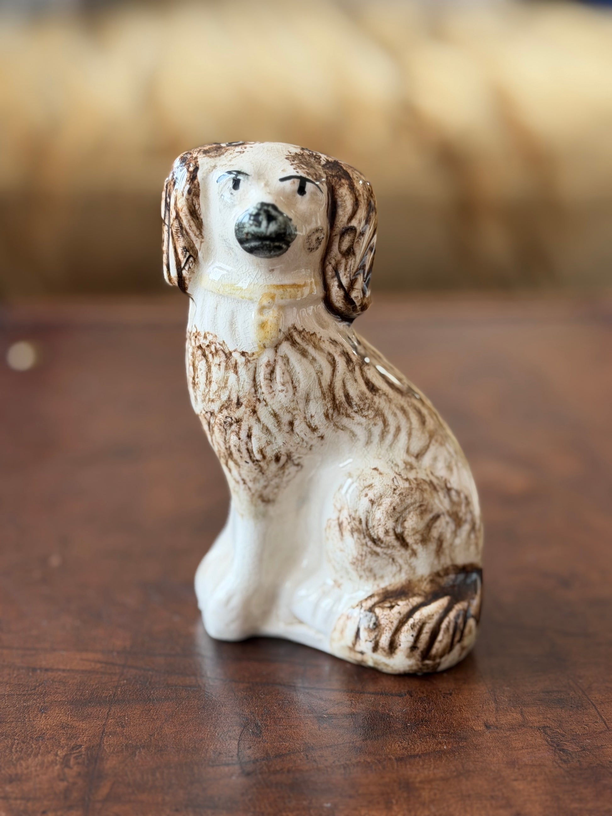 Small ceramic staffordshire spaniel with brown painted features