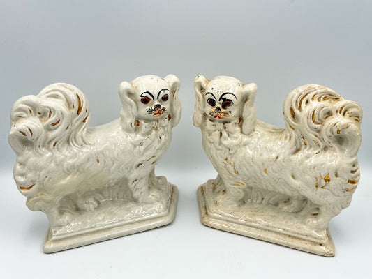 Pair of Staffordshire Pekingese Dogs standing on bases.