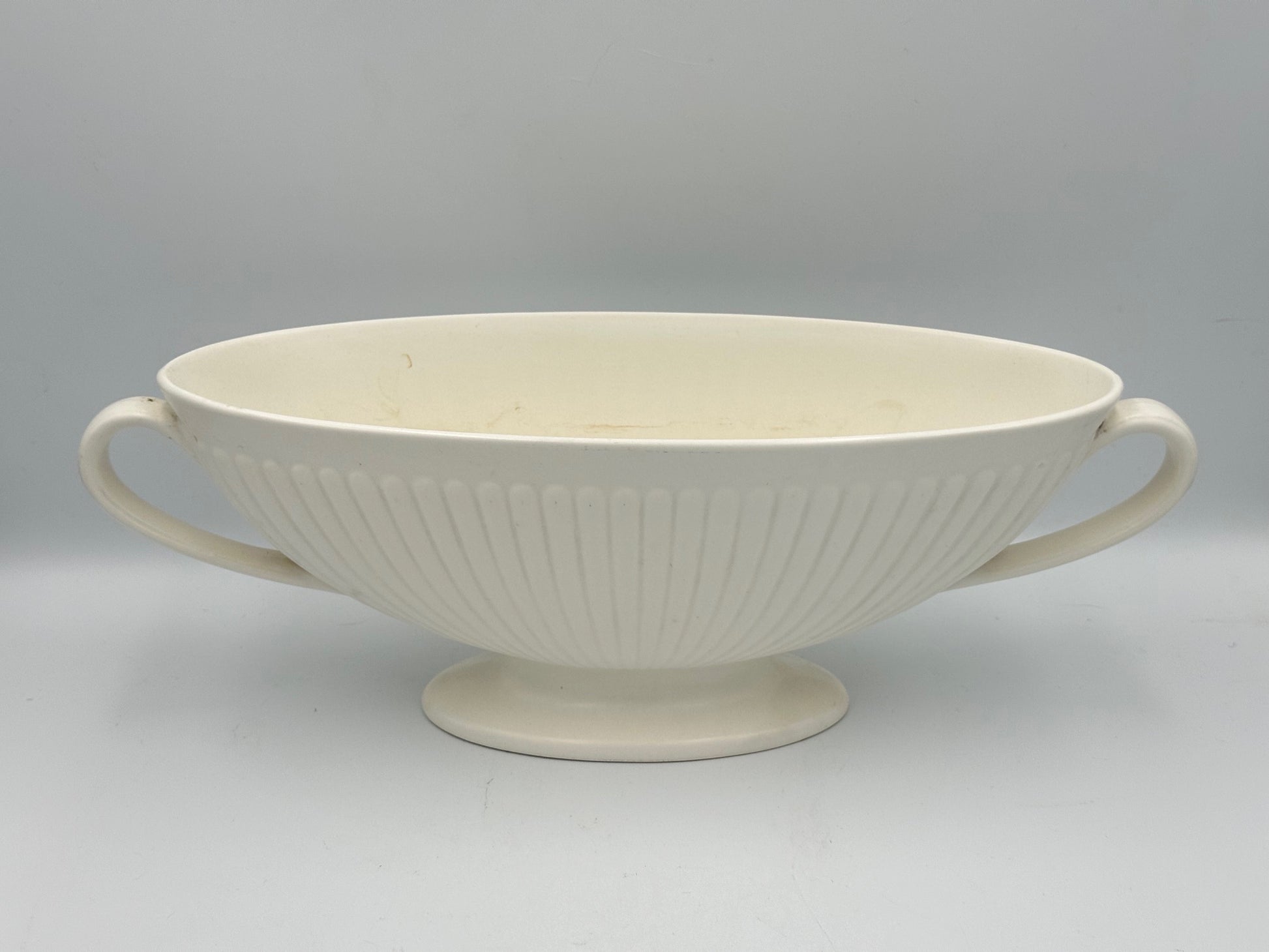 A Wedgwood white moonstone mantle vase with a ribbed and fluted design, featuring a footed base.