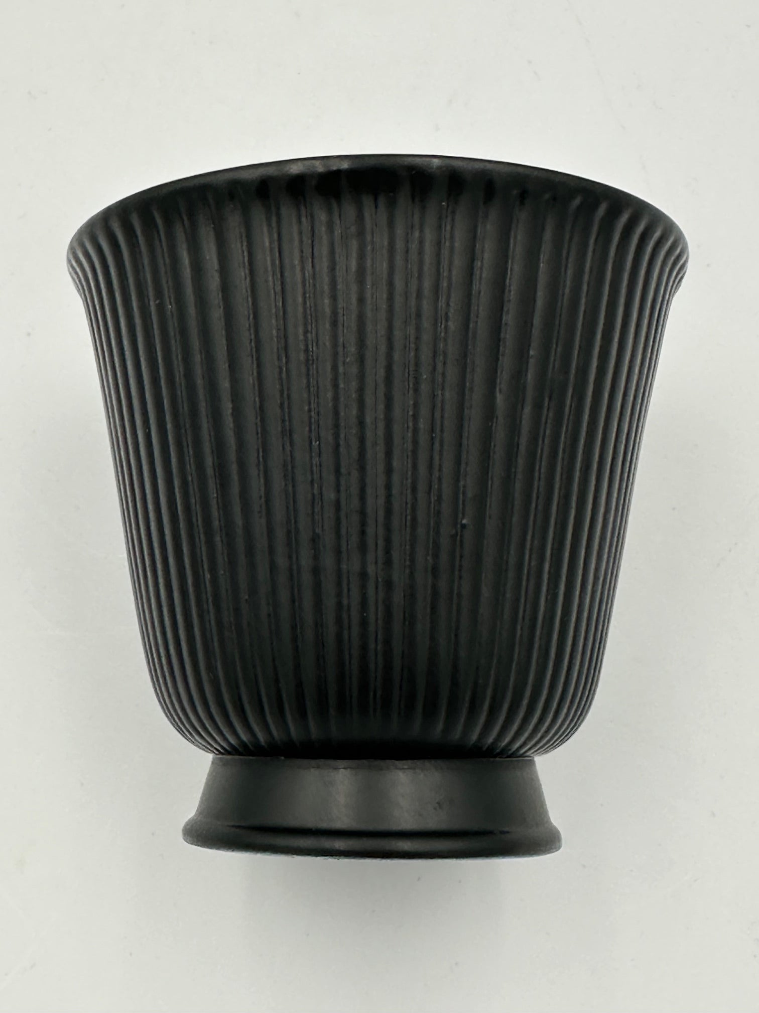 A vintage Wedgwood black Ravenstone small trumpet vase with a ribbed design.