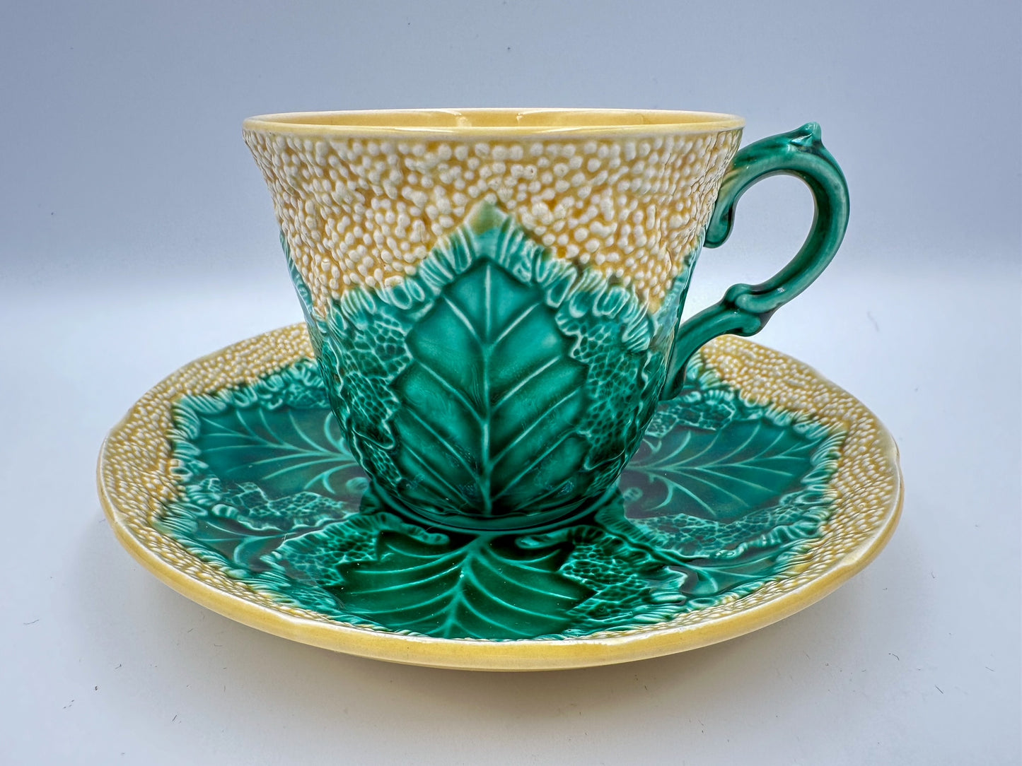A wedgwood teacup and saucer that resembles cauliflower